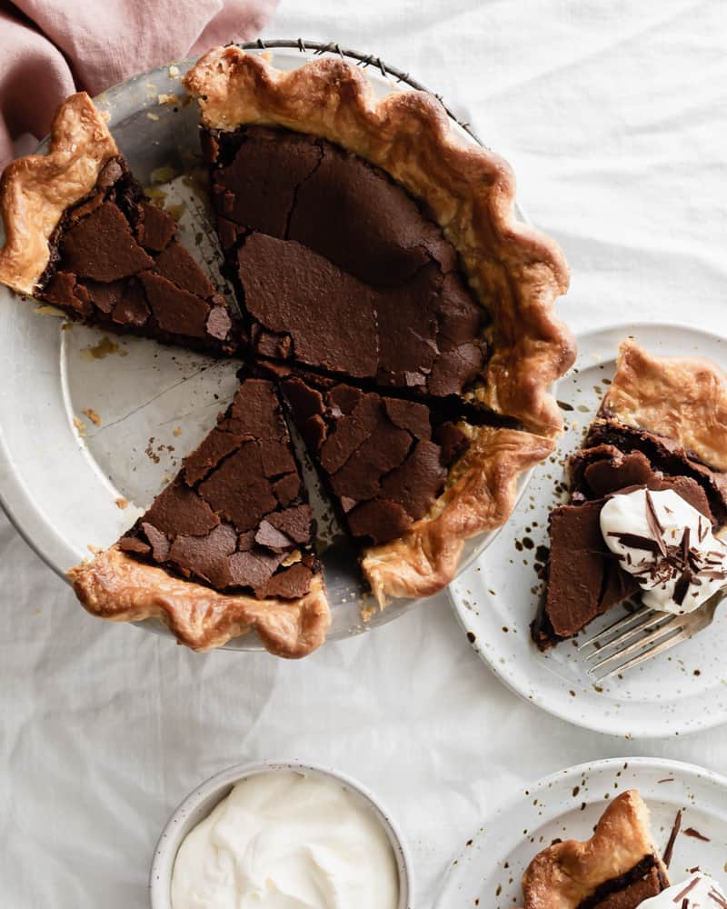 Fudgy dark chocolate chess pie with a crackly brownie top and fudgy center ready to be served