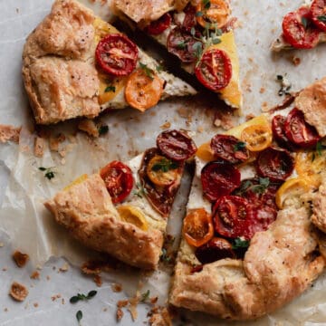 Baked and sliced heirloom tomato galette with ricotta, pistachio pesto and a flaky, buttery pie crust